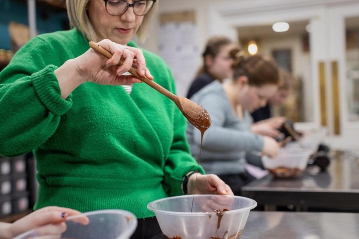 a woman stirring a bowl with a wooden spoon