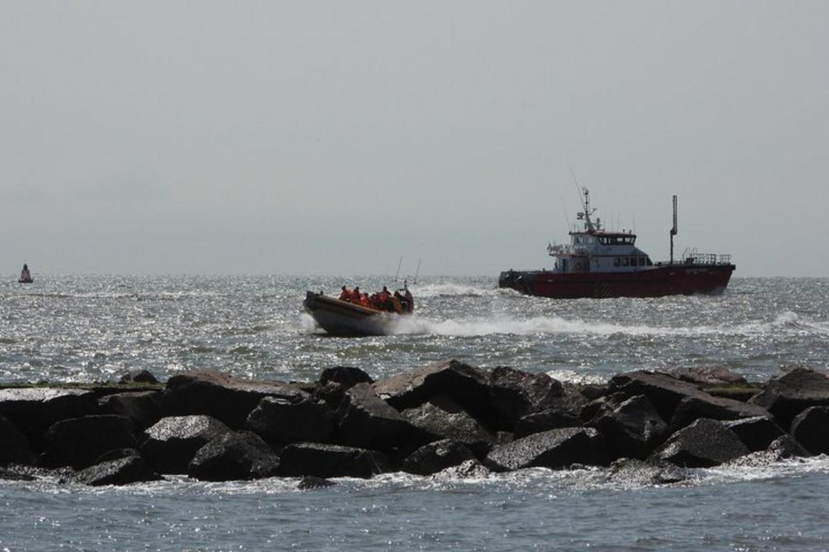 a boat in the water with a larger boat