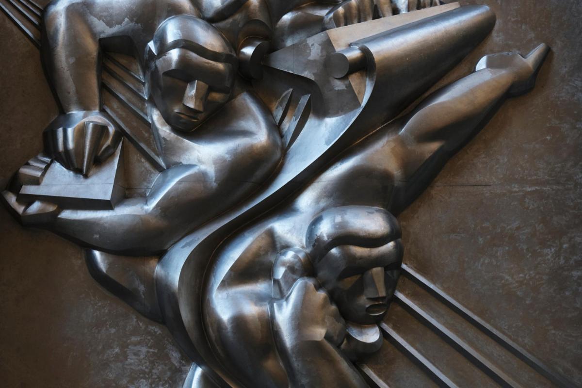 a bronze statue of a woman holding
