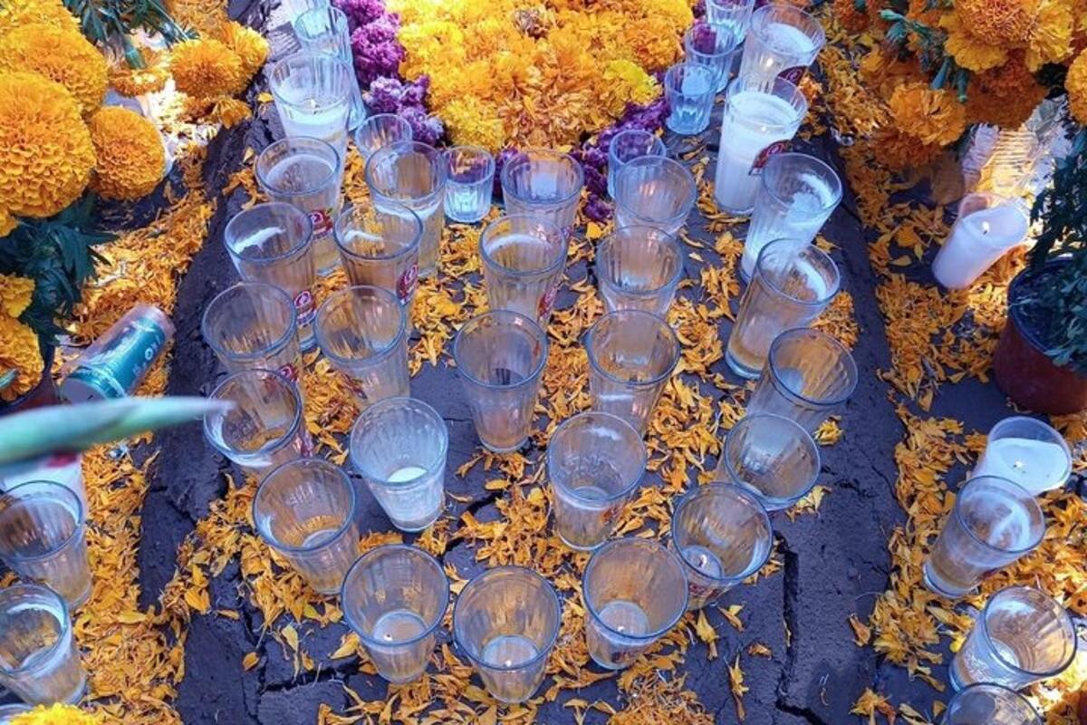 a bunch of cups sitting on a table with flowers