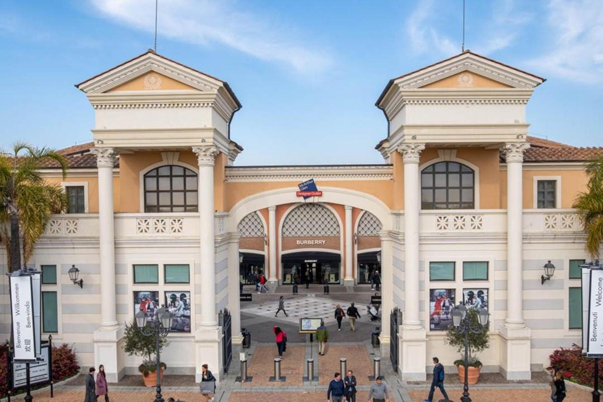 a large building with people walking in front of it