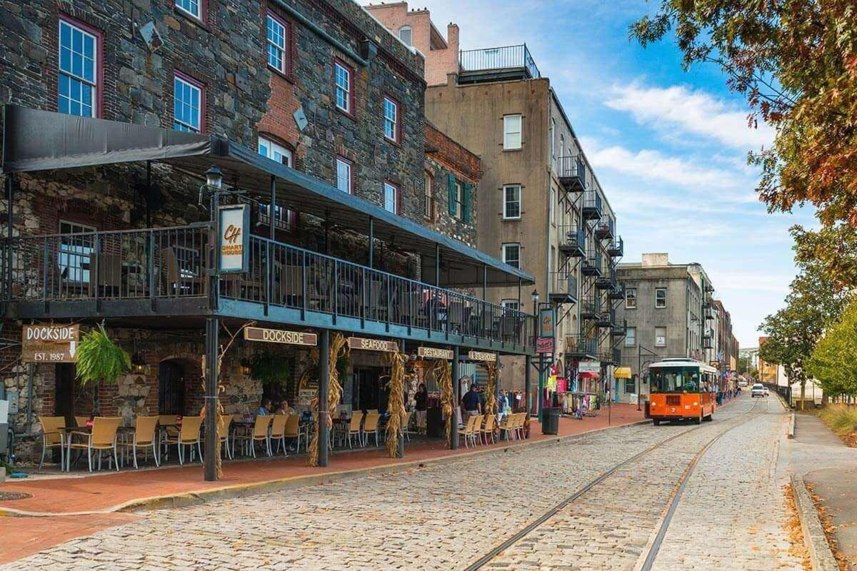 a tram on a street in a city with buildings