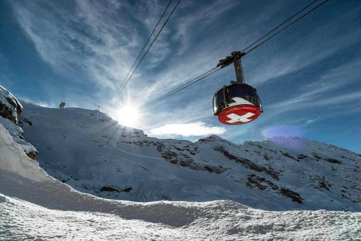 a ski lift going up a snow covered mountain