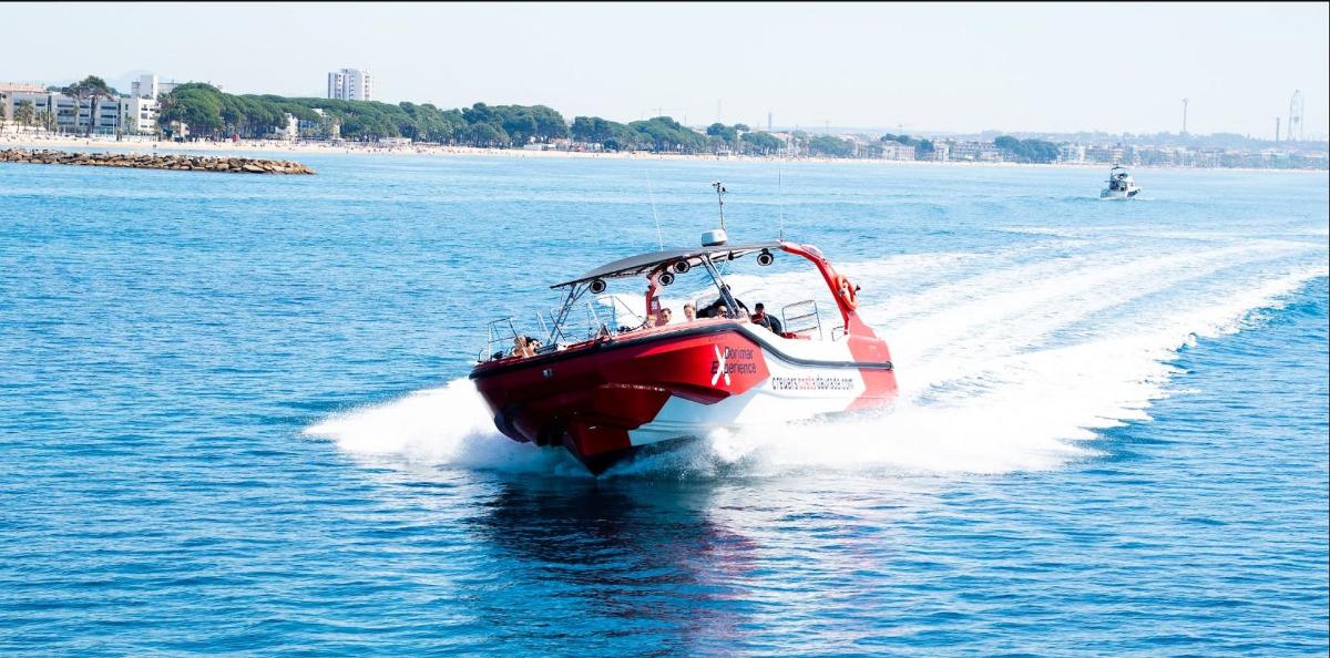 a red boat in the water on a body of water
