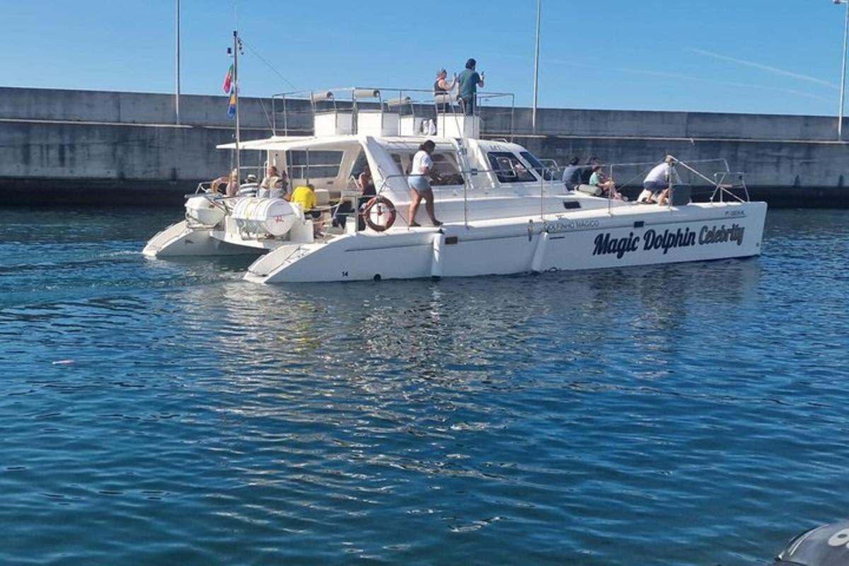 a white boat in the water with people on it