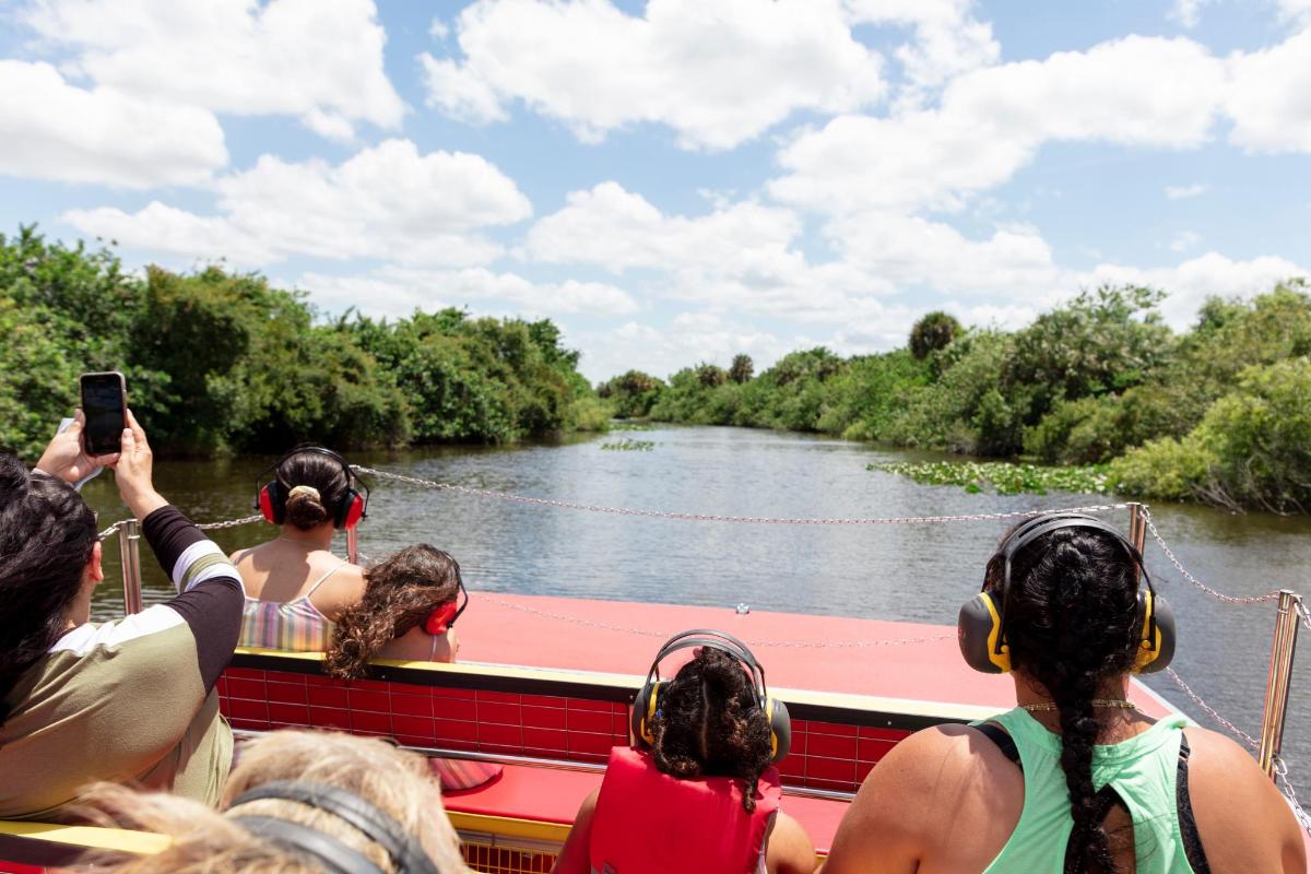 a group of people riding on a boat on a river