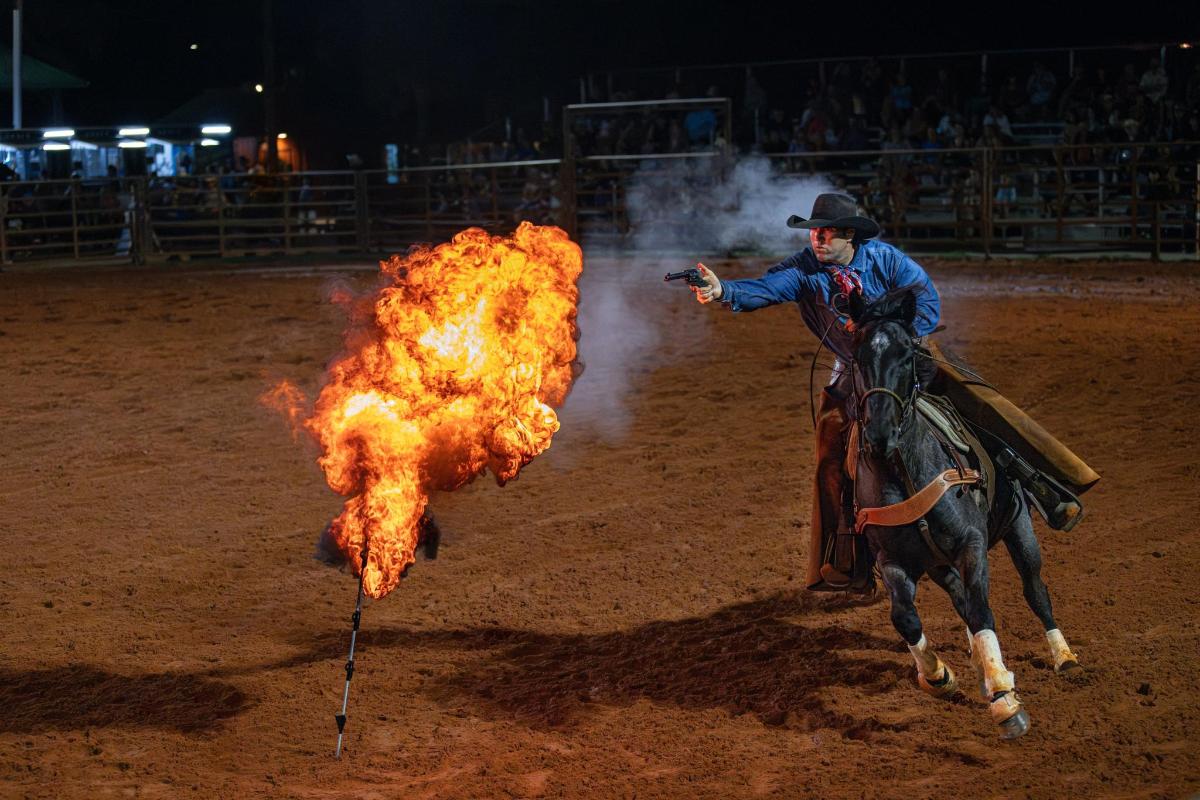 a man on a horse with a fire in the dirt