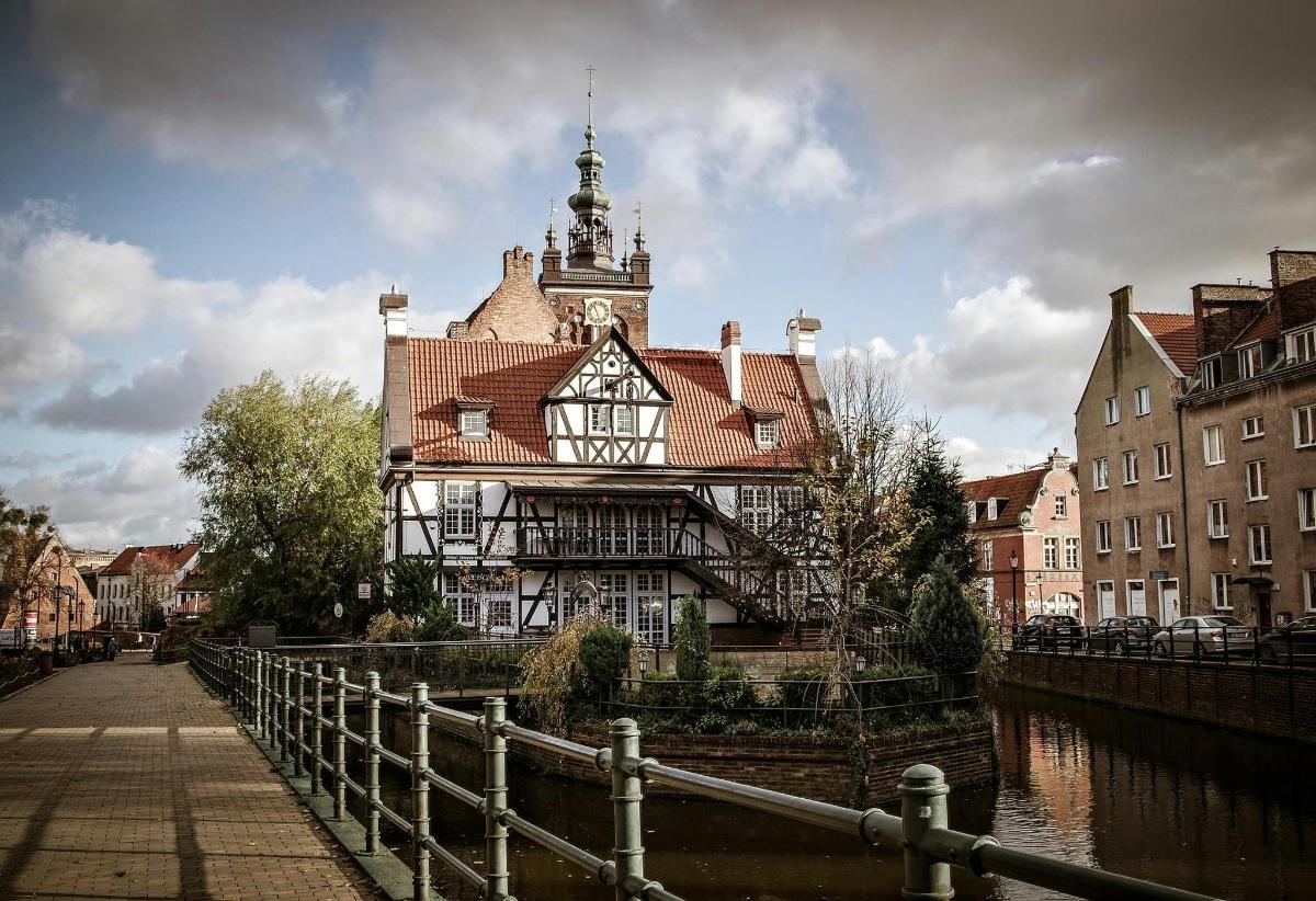 a building with a clock tower on top of a river