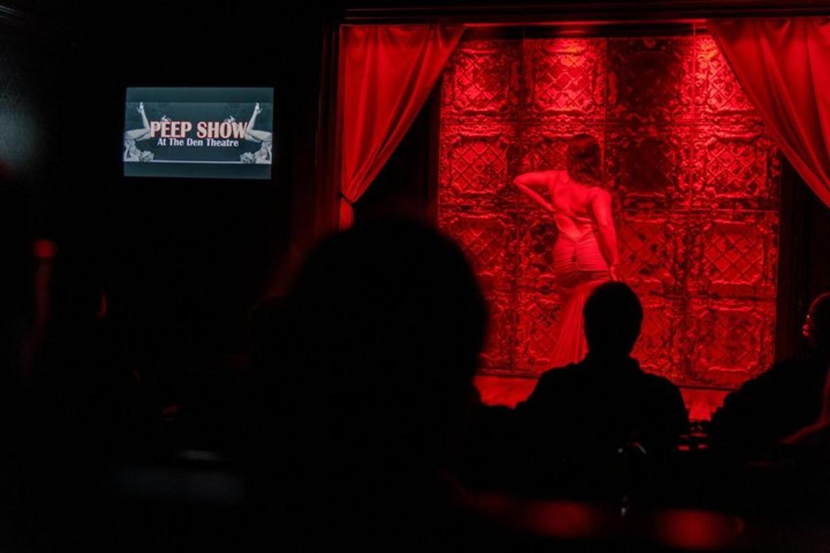 a woman in a red dress standing on a stage