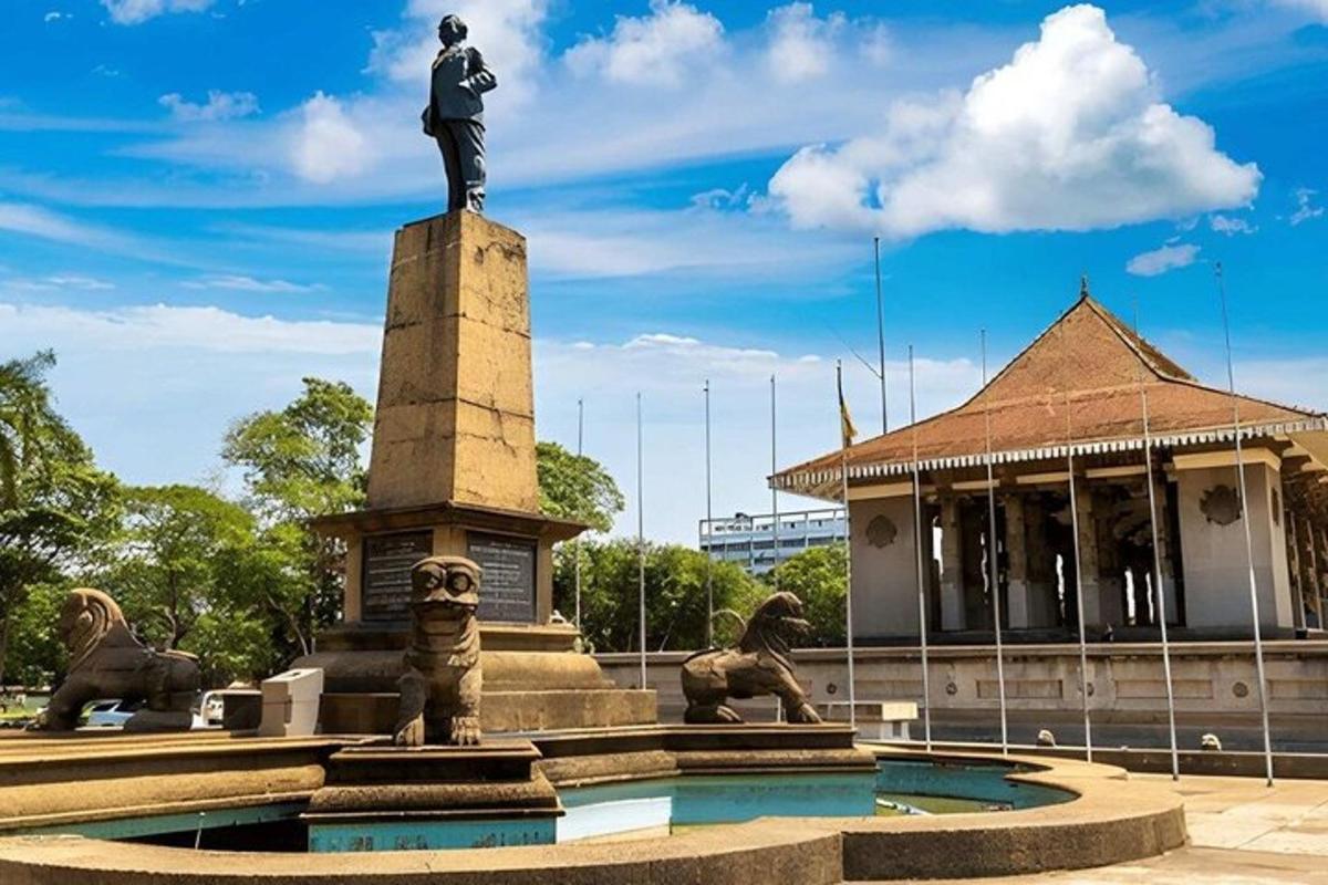 a statue of a man standing on top of a fountain