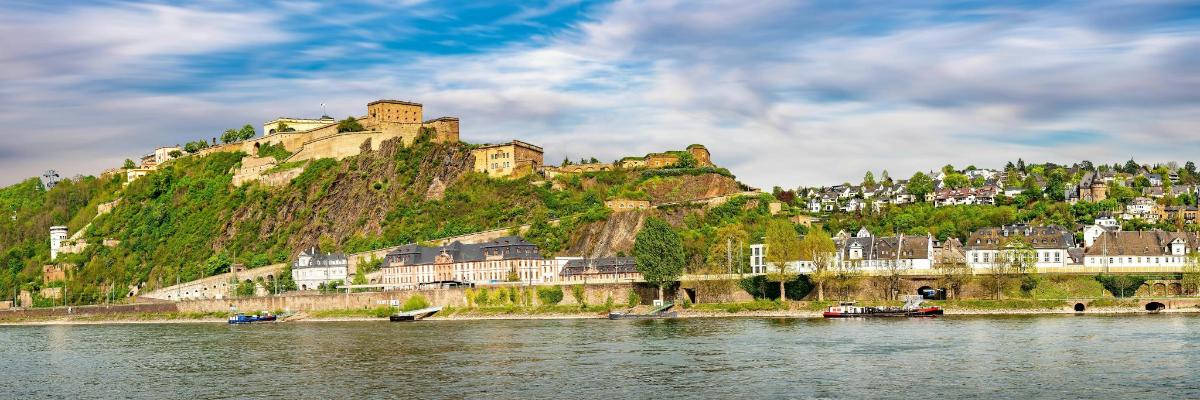 a castle on top of a hill next to the water