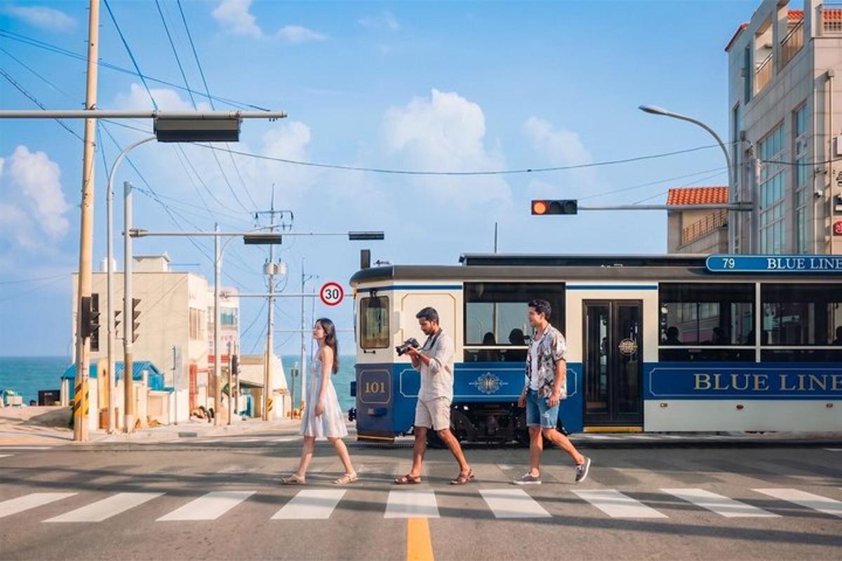 a group of people crossing a street in front of a bus
