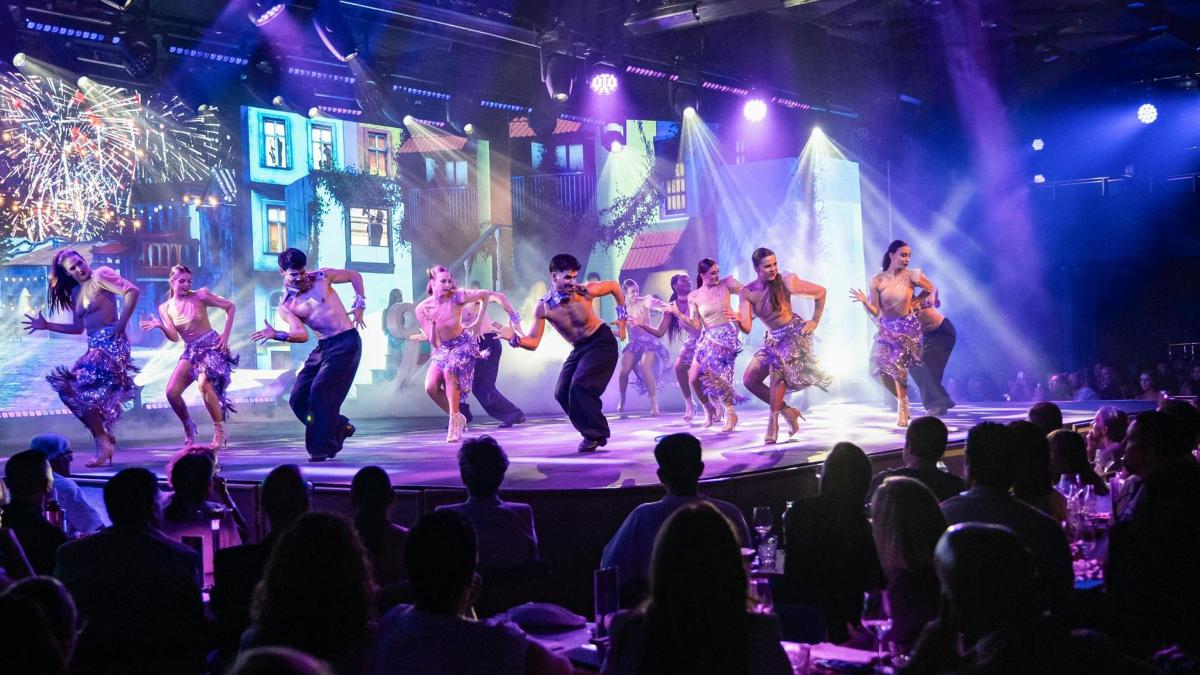 a group of performers on a stage with a crowd