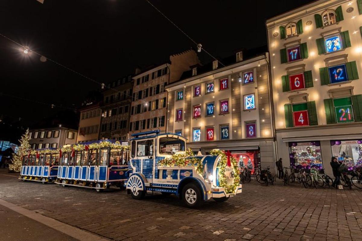 a small train car on a city street at night