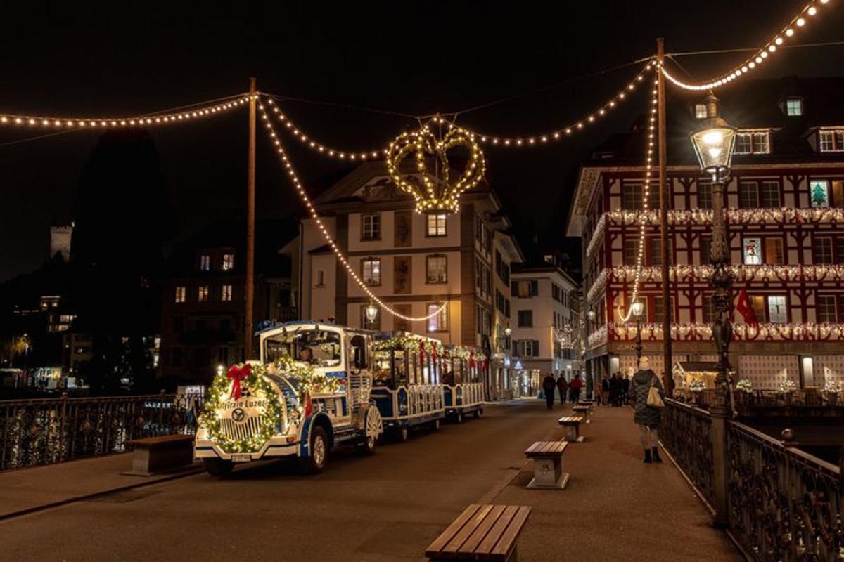 a christmas truck driving down a street with christmas lights