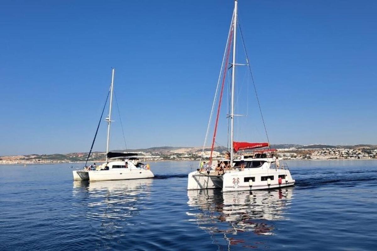 two sailboats floating in the water on a lake