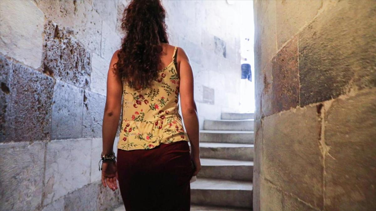 a woman is walking down some stairs
