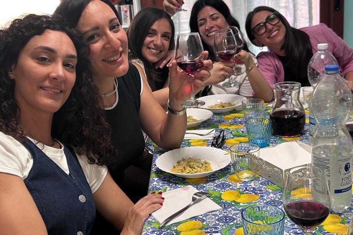 a group of women sitting at a table with wine glasses