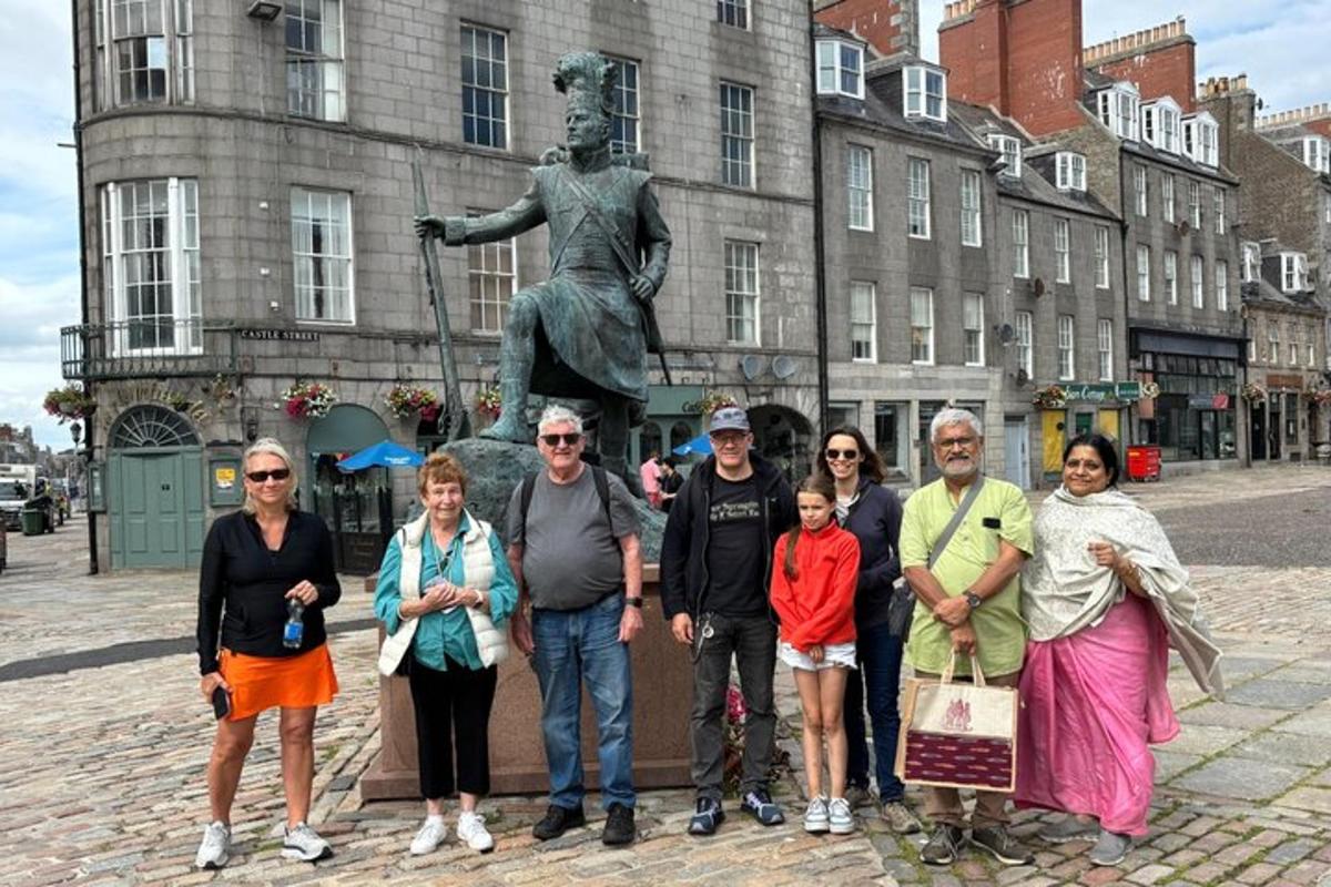 a group of people standing in front of a statue