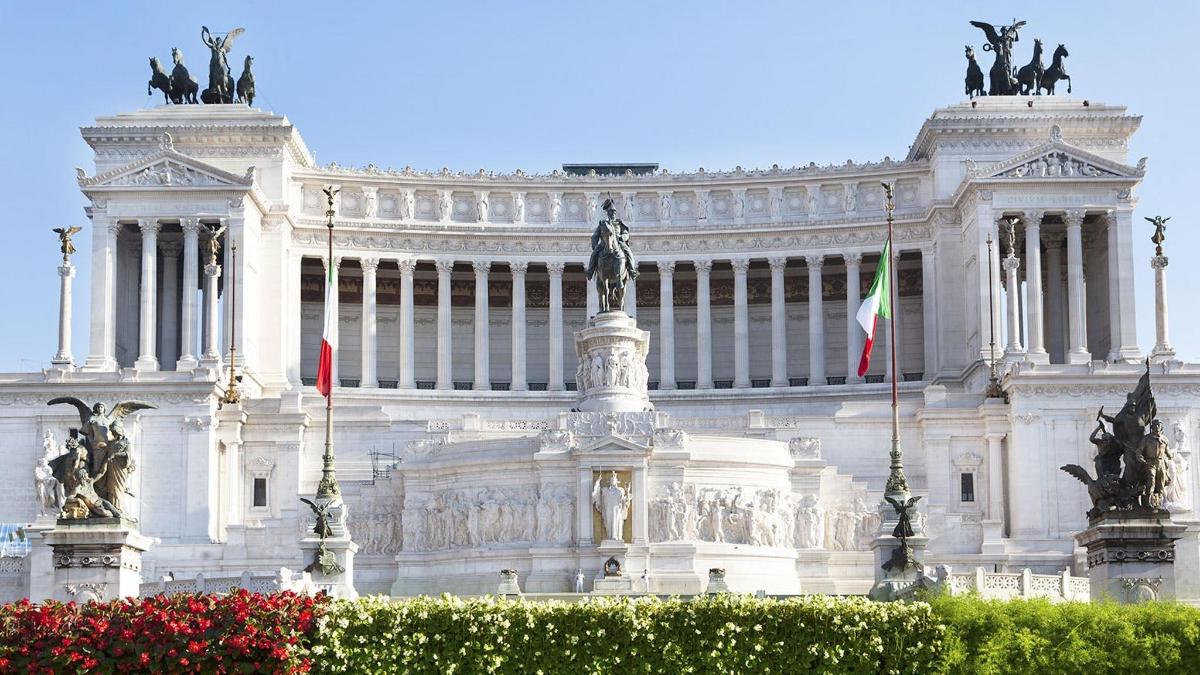 a white building with flags in front of it