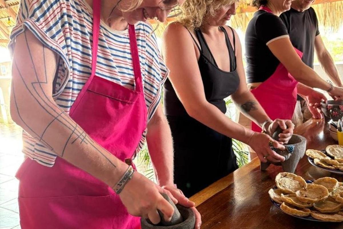 a group of people standing around a table preparing food