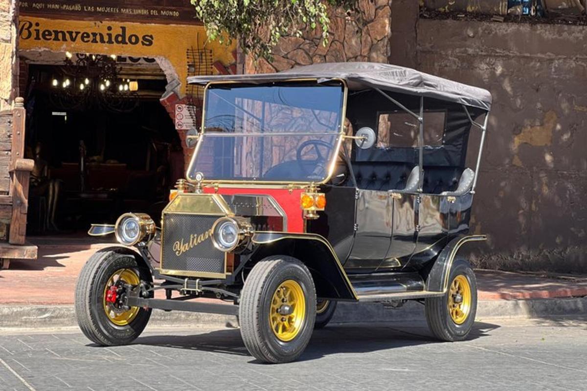 an old black car is parked on the street