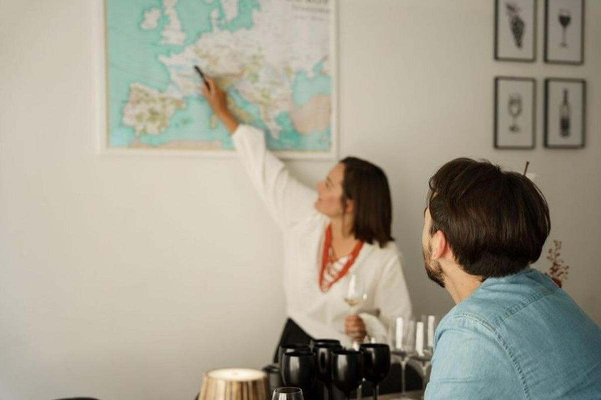 a woman is pointing to a map on a wall