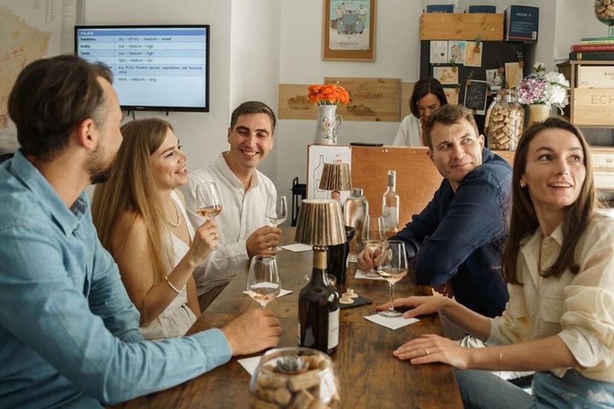 a group of people sitting around a table with wine glasses