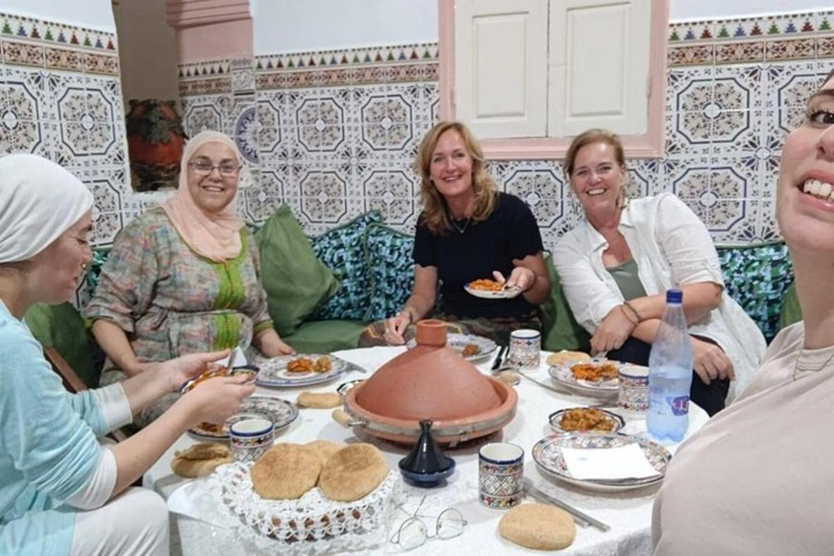 a group of women sitting around a table with food