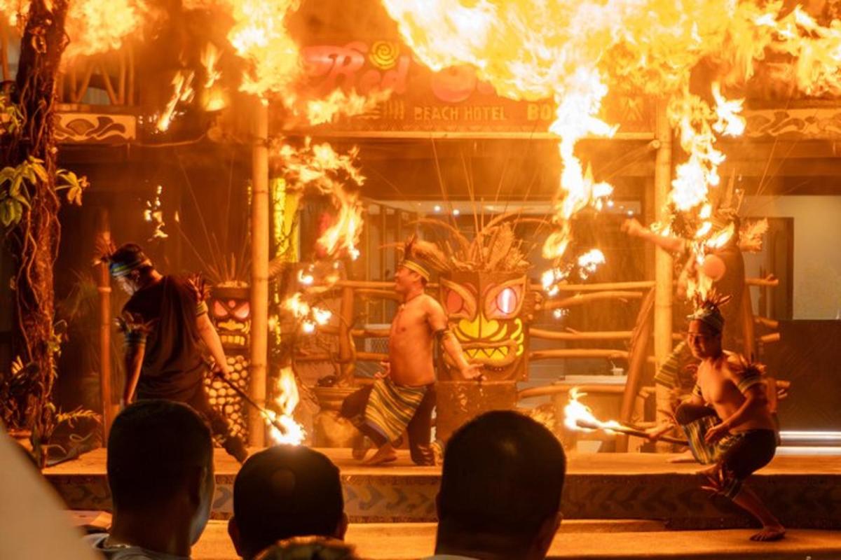 a group of people on a stage with fire