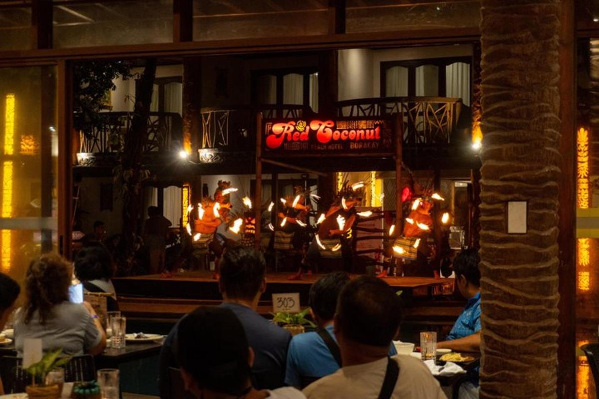 a group of people sitting at tables in a restaurant