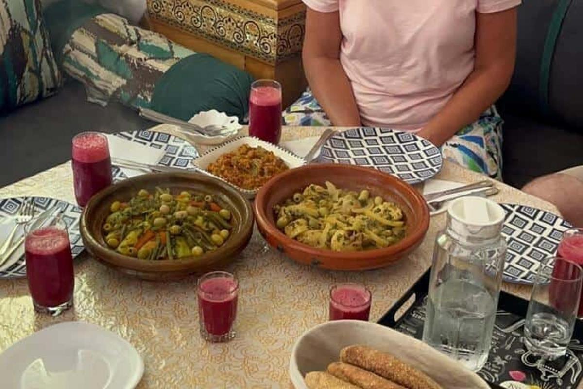 a woman sitting at a table with bowls of food
