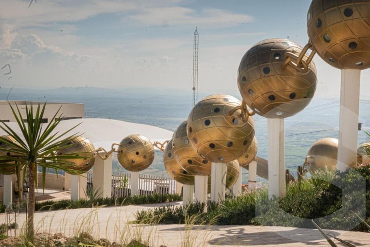 a group of metal spheres on display in front of a building