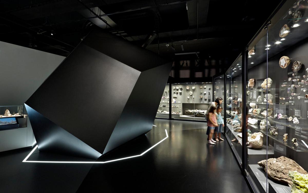 two people looking at a display case in a museum