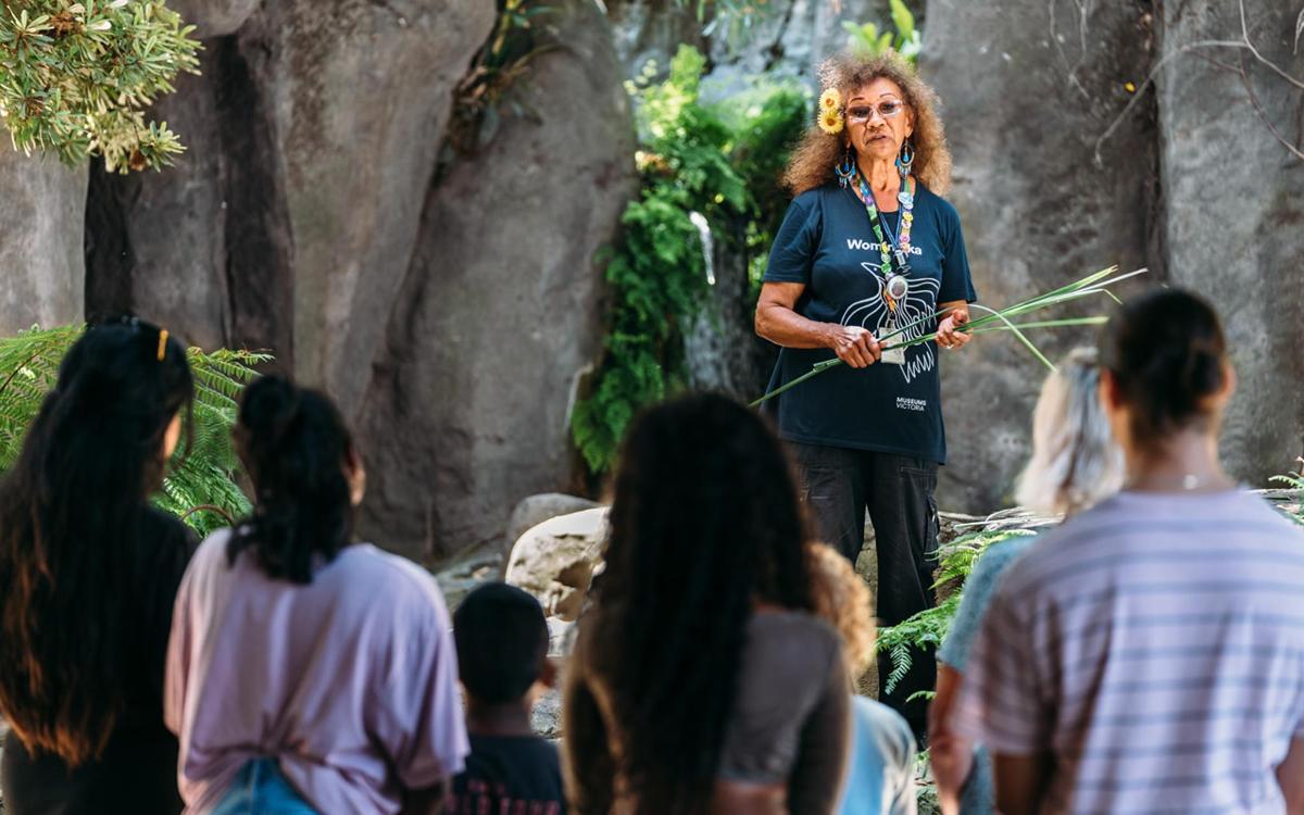 a woman standing in front of a crowd of people