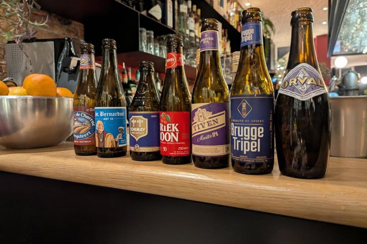 a row of bottles of beer sitting on a bar