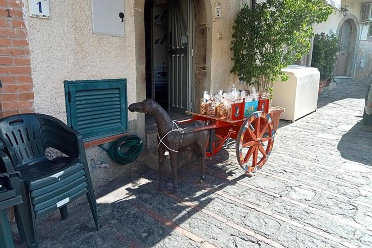 a horse pulling a cart in front of a building
