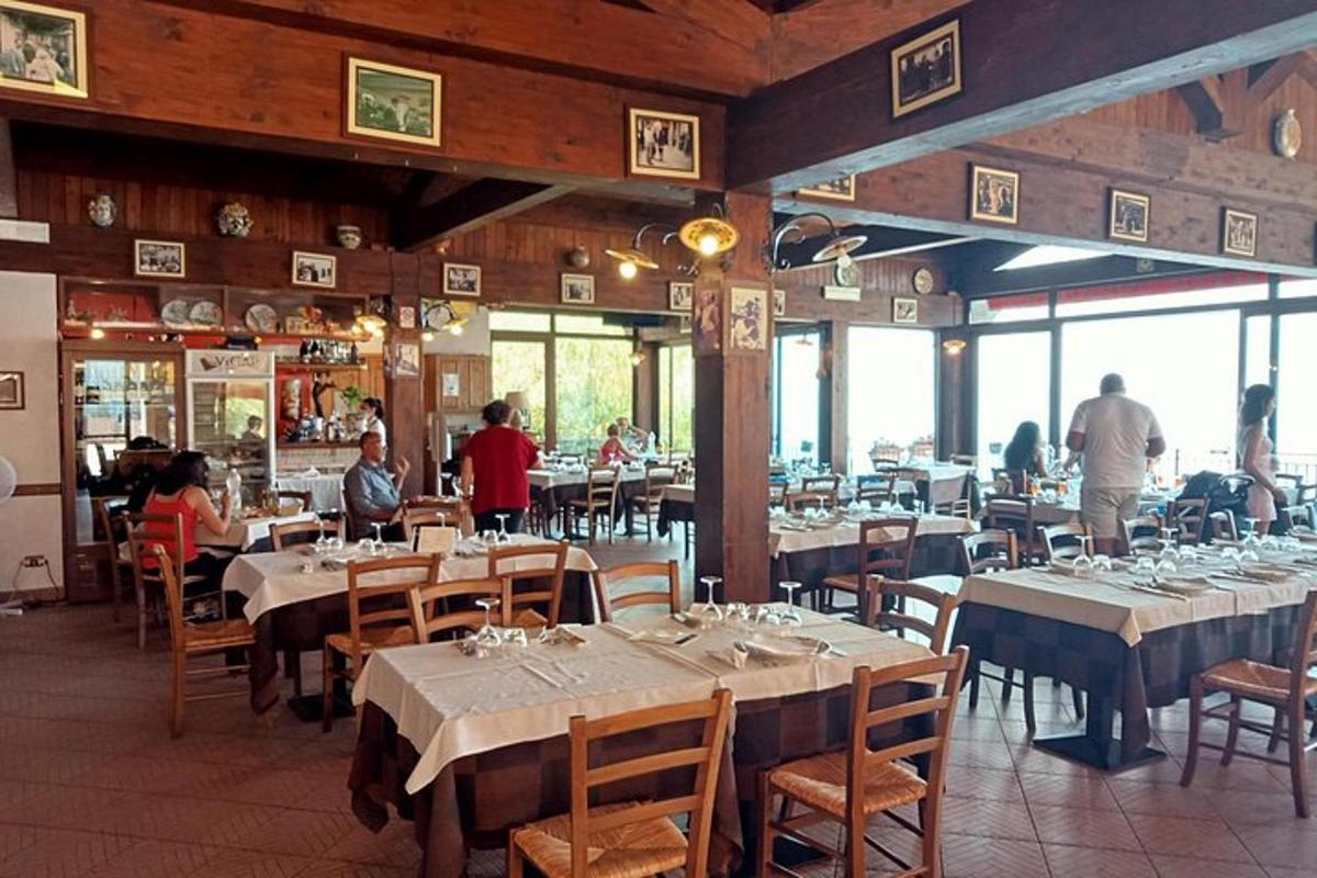 a dining room with tables and people in a restaurant