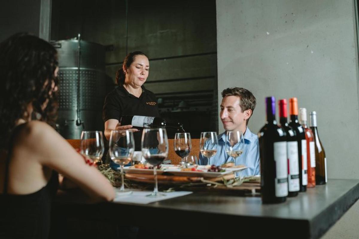 a man and woman sitting at a table with wine glasses
