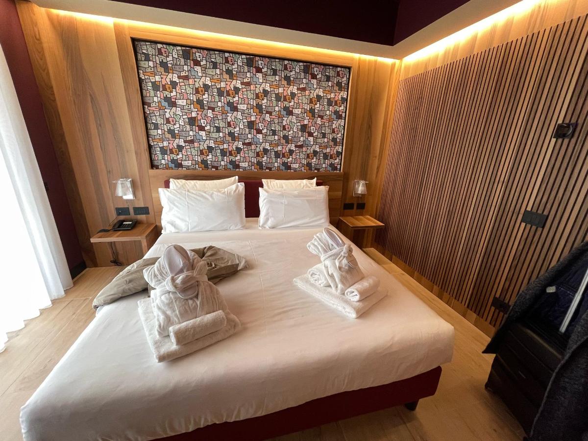 Letto o letti in una camera di Alevic Hotel Sirmione