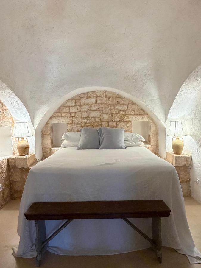 Letto o letti in una camera di Masseria Soluco